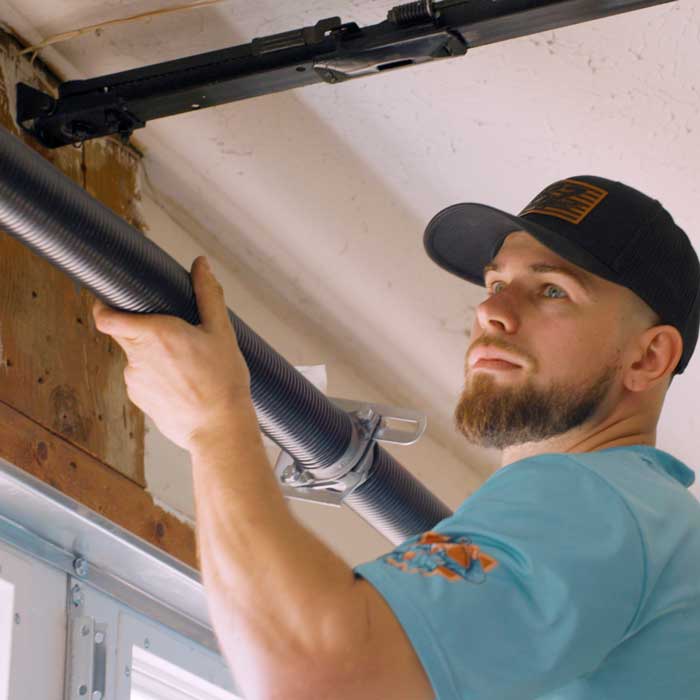 An Ohio Garage Door Repair technician installing a garage door spring