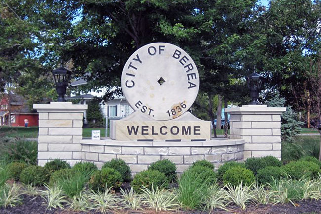 A garage door repair technician is installing a new garage door spring near Berea, OH