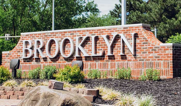 A garage door repair technician is installing a new garage door spring near Brooklyn, OH